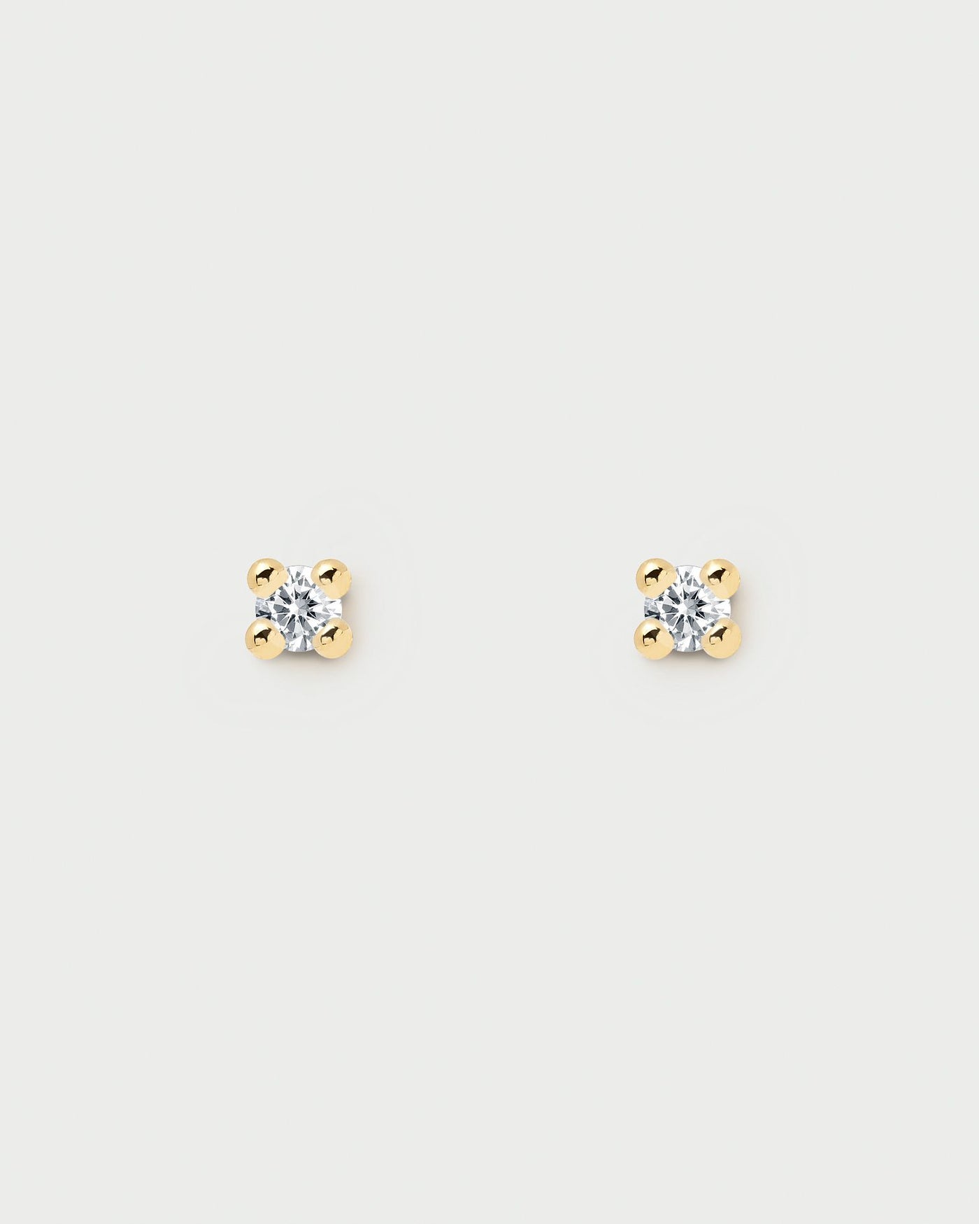 2024 Selection | Essentia Earrings. Pair of 18k gold plated silver stud earrings set with a white zirconia stone. Get the latest arrival from PDPAOLA. Place your order safely and get this Best Seller. Free Shipping.