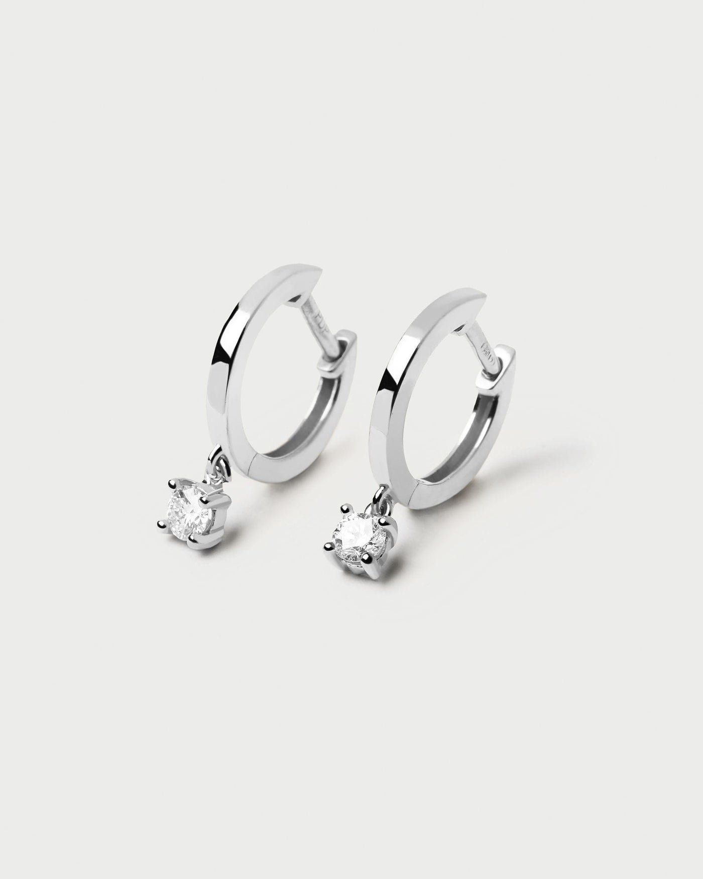 2024 Selection | Diamonds and White Gold Drop Hoops. Hoop earrings in solid white gold with hanging lab-grown diamond of 0.10 carats each. Get the latest arrival from PDPAOLA. Place your order safely and get this Best Seller. Free Shipping.